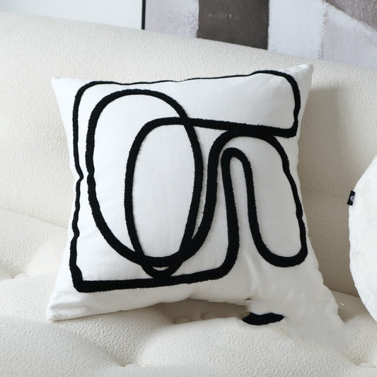 Almohada bordada con líneas en blanco y negro: diseño moderno y sencillo